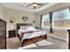 Spacious bedroom with a large bed, dresser, and plenty of natural light at 4434 Micanope Crescent Dr, Lakeland, FL 33811