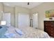 Guest bedroom with a comfortable bed and a view of the hallway at 4434 Micanope Crescent Dr, Lakeland, FL 33811