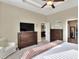 Bright bedroom featuring a comfortable bed, large TV, and ample closet space at 4434 Micanope Crescent Dr, Lakeland, FL 33811