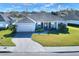 Exterior view of a single-Gathering home with a well-manicured lawn and paver driveway at 4434 Micanope Crescent Dr, Lakeland, FL 33811