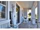 Covered front porch featuring rocking chairs and a welcoming entrance at 4434 Micanope Crescent Dr, Lakeland, FL 33811