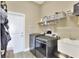 Convenient laundry room with washer, dryer, and ample storage shelving at 4434 Micanope Crescent Dr, Lakeland, FL 33811