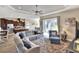 Spacious living room with sectional sofa, large windows, and open kitchen view at 4434 Micanope Crescent Dr, Lakeland, FL 33811