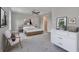 Bright bedroom with wood dresser and comfy chairs at 460 N 1St Ave, Bartow, FL 33830
