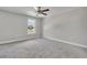 Simple bedroom with grey carpet and ceiling fan at 460 N 1St Ave, Bartow, FL 33830