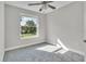 Bright bedroom with grey carpet and large window at 460 N 1St Ave, Bartow, FL 33830