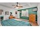 Bright main bedroom featuring an emerald accent wall, a window, and hardwood floors at 4607 Palmetto Dr, Winter Haven, FL 33881