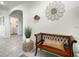 Inviting entryway with a wooden bench, decorative mirror, and potted plant at 507 Autumn Stream Dr, Auburndale, FL 33823