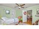 Cozy bedroom featuring hardwood floors, a ceiling fan, and a comfortable bed with a colorful quilt at 531 Hunter St, Lakeland, FL 33803