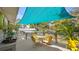 Outdoor deck with seating area under a blue sunshade, surrounded by lush plants at 531 Hunter St, Lakeland, FL 33803