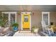 Charming front porch featuring a bright yellow door and rocking chairs at 531 Hunter St, Lakeland, FL 33803