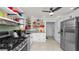 Bright kitchen with stainless steel appliances, white cabinets, granite countertops, and decorative open shelving at 531 Hunter St, Lakeland, FL 33803