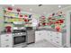 Bright kitchen with stainless steel appliances, granite countertops, and decorative shelving with colorful dishware at 531 Hunter St, Lakeland, FL 33803