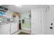 Convenient laundry room with washer, dryer, and storage shelves at 531 Hunter St, Lakeland, FL 33803