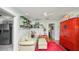 Living room with beadboard walls, leading into kitchen and red cabinet at 531 Hunter St, Lakeland, FL 33803