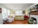 A living room showcasing the hardwood flooring, natural light, and fireplace at 531 Hunter St, Lakeland, FL 33803