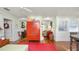 Inviting living room with hardwood floors, bright walls, and statement red cabinet at 531 Hunter St, Lakeland, FL 33803