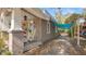 Comfortable side porch with seating, shade canopy, and view of the adjacent yard and trees at 531 Hunter St, Lakeland, FL 33803