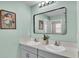 Double vanity bathroom with updated fixtures and large mirror at 5598 Arlington River Dr, Lakeland, FL 33811