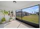 Cozy screened porch with view of backyard and neighboring houses at 5771 Lacar Way, Lakeland, FL 33805