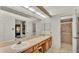 Bathroom featuring double sinks with vanity, shower and tiled floors at 6228 Crane Dr, Lakeland, FL 33809