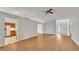 Bright living room featuring wood floors, a ceiling fan, and neutral wall paint at 6228 Crane Dr, Lakeland, FL 33809