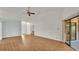 Bright living room showcasing wood floors, an open floor plan, ceiling fan, and sliding glass doors at 6228 Crane Dr, Lakeland, FL 33809