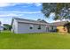 Gray house with patio, fire pit, and green lawn at 6235 Egret Dr, Lakeland, FL 33809