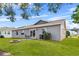Gray house with patio, fire pit, and green lawn at 6235 Egret Dr, Lakeland, FL 33809