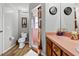 Clean bathroom with pink tile shower, wood vanity, and updated fixtures at 6235 Egret Dr, Lakeland, FL 33809