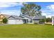 Gray house with white garage door and green lawn at 6235 Egret Dr, Lakeland, FL 33809