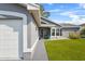 Gray house with white garage door, walkway, and green lawn at 6235 Egret Dr, Lakeland, FL 33809