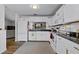 Bright eat-in kitchen, featuring white cabinets, granite countertops, and modern appliances at 6235 Egret Dr, Lakeland, FL 33809