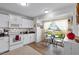Clean kitchen with white cabinets, granite counters, and an eat-in area at 6235 Egret Dr, Lakeland, FL 33809