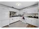 Bright eat-in kitchen, featuring white cabinets, granite countertops, and modern appliances at 6235 Egret Dr, Lakeland, FL 33809