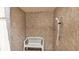 Accessible shower with bench seating and hand-held shower head at 6235 Egret Dr, Lakeland, FL 33809