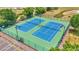 Two well-lit outdoor tennis courts at 6235 Egret Dr, Lakeland, FL 33809