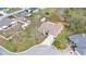 Aerial view of the home in the neighborhood with lush landscaping at 6244 Napa Dr, Lakeland, FL 33813
