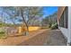 View of the backyard with a wood fence, a gravel walkway and ground cover at 6244 Napa Dr, Lakeland, FL 33813