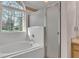 Bathroom featuring a glass shower door and a garden tub beneath a large window at 6244 Napa Dr, Lakeland, FL 33813