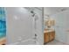 Modern bathroom features dual shower heads, white tile, and vanity with storage at 6244 Napa Dr, Lakeland, FL 33813