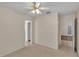 Carpeted bedroom featuring a ceiling fan and access to the bathroom at 6244 Napa Dr, Lakeland, FL 33813