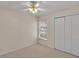 Neutral bedroom featuring a ceiling fan, carpet, and a double door closet at 6244 Napa Dr, Lakeland, FL 33813