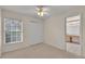 Bright bedroom featuring a ceiling fan, carpet, and an ensuite bathroom at 6244 Napa Dr, Lakeland, FL 33813