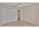 A neutral bedroom with a ceiling fan, and a closet for storage at 6244 Napa Dr, Lakeland, FL 33813