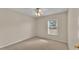Neutral bedroom featuring a window for natural lighting and a ceiling fan at 6244 Napa Dr, Lakeland, FL 33813