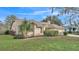 Exterior elevation of the home with mature landscaping and a circular driveway at 6244 Napa Dr, Lakeland, FL 33813