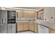 Kitchen area featuring stainless steel refrigerator, white dishwasher, and cabinets with light countertops at 6244 Napa Dr, Lakeland, FL 33813