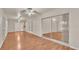 Bright living room with hardwood floors, sliding glass doors, and multiple ceiling fans at 6244 Napa Dr, Lakeland, FL 33813