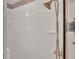 Close up of the shower with a brass shower head and white tiled walls at 6244 Napa Dr, Lakeland, FL 33813